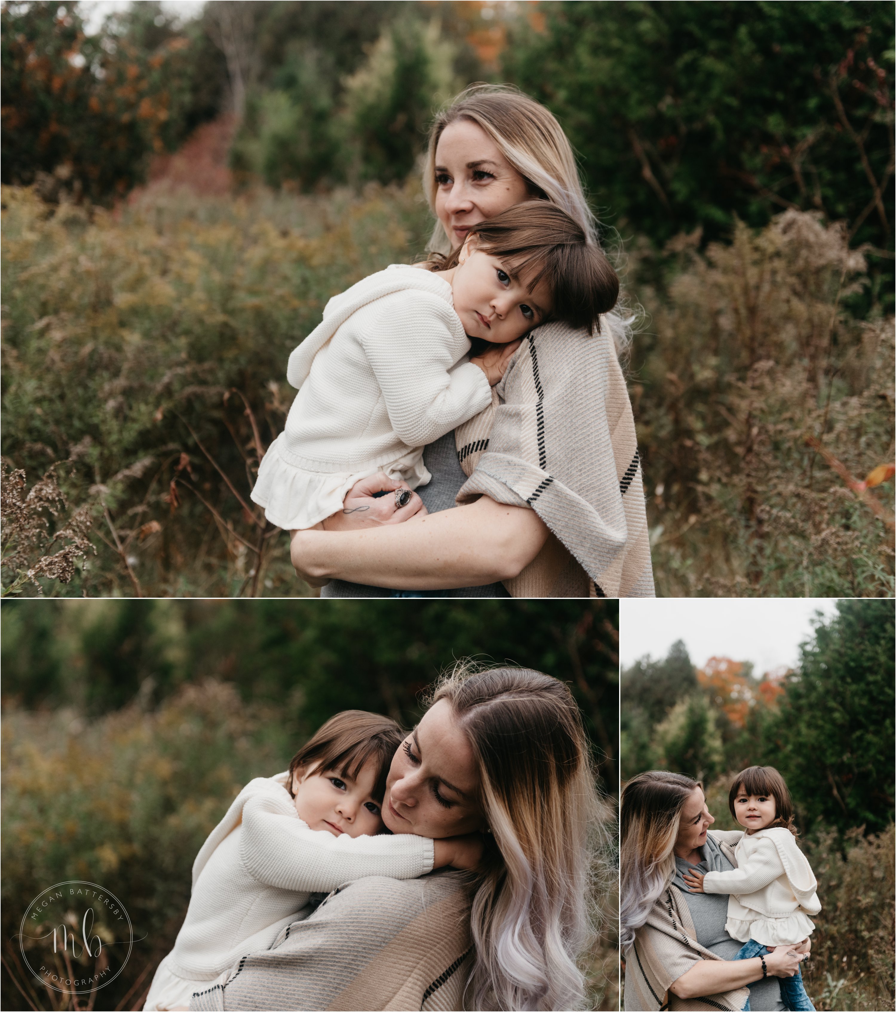 Young girl snuggling in to mom standing in field of tall grass